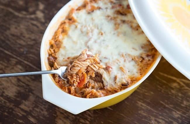 Macaroni Chop Suey in a large yellow casserole dish on wood background