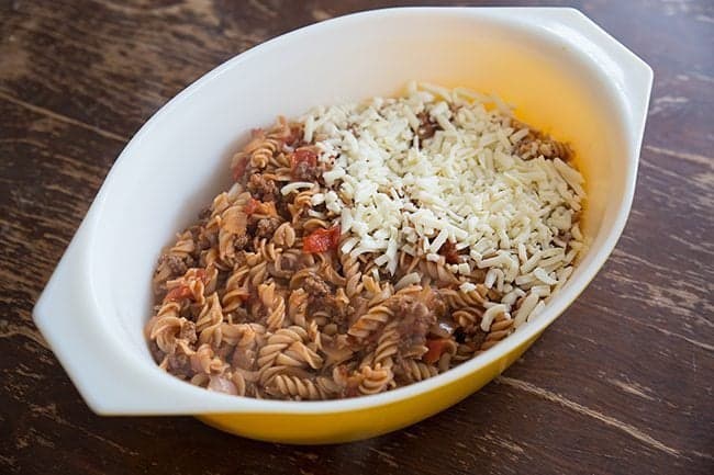 large yellow casserole with noodles top with the cheese and chop suey