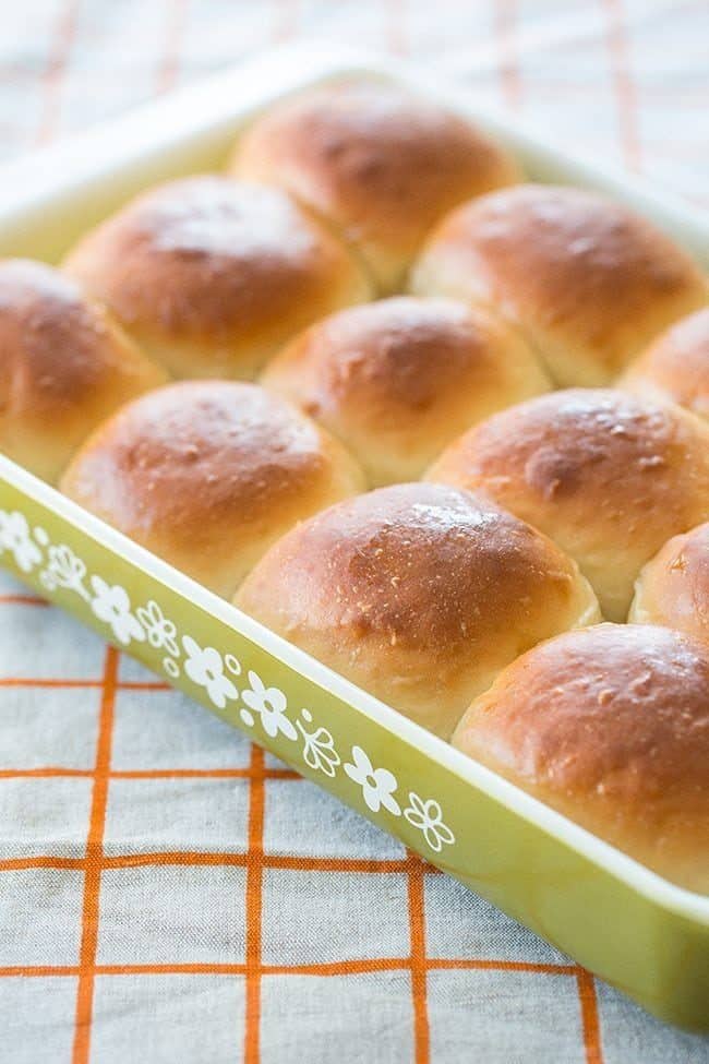 Close up of Old-Fashioned Southern Honey Butter Rolls in Pyrex baking pan