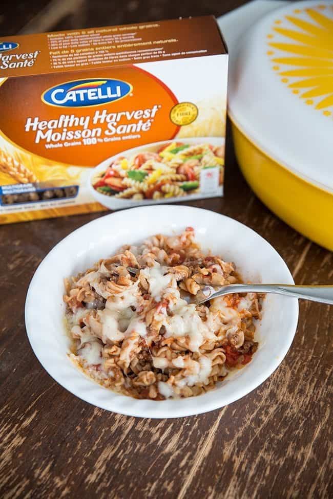 Macaroni Chop Suey in a White Bowl, Box of Catelli Macaroni and large yellow casserole dish at the back