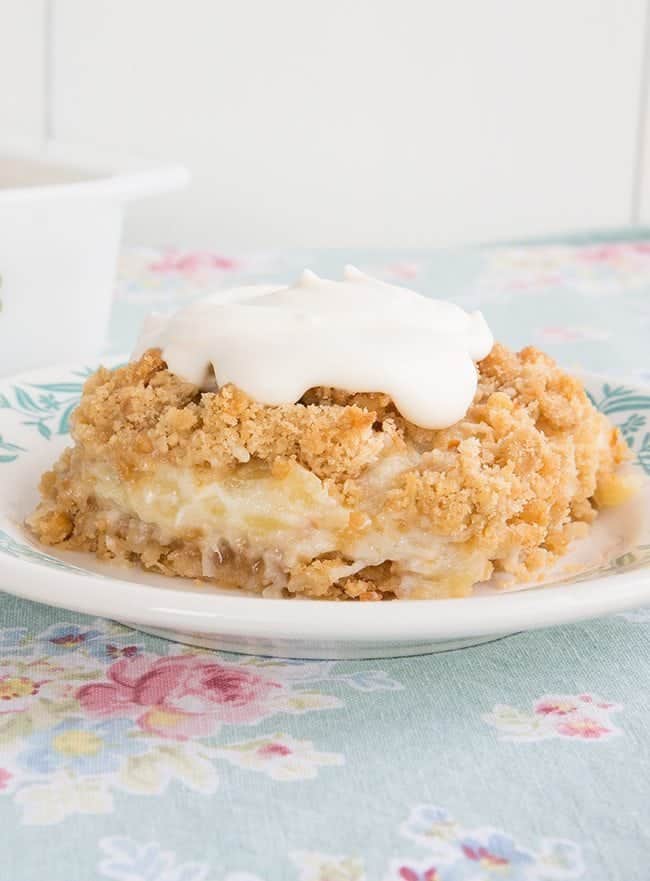  Close up of Pineapple Soda Cracker Dessert served with dollop of whipped cream on top