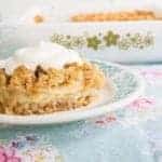 Pineapple Soda Cracker Dessert served with dollop of whipped cream on top in a plate and in a baking dish at the back
