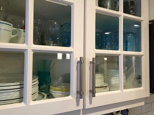 kitchen cabinet with plates and bowls inside