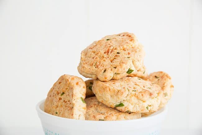 Close up of Cheddar & Chive Biscuits on white background