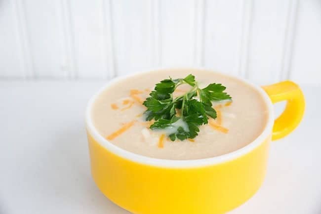 Cream of Chicken and Cauliflower Soup Topped with Shredded Cheese and Parsley