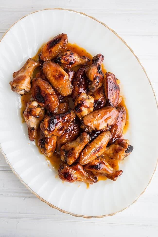 Detroit Honey Hot Wings in a white serving plate with hot butter sauce