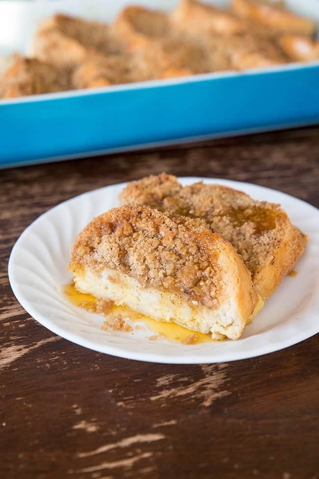 close up Slices of overnight french toast in white plate with cinnamon crunch toppings