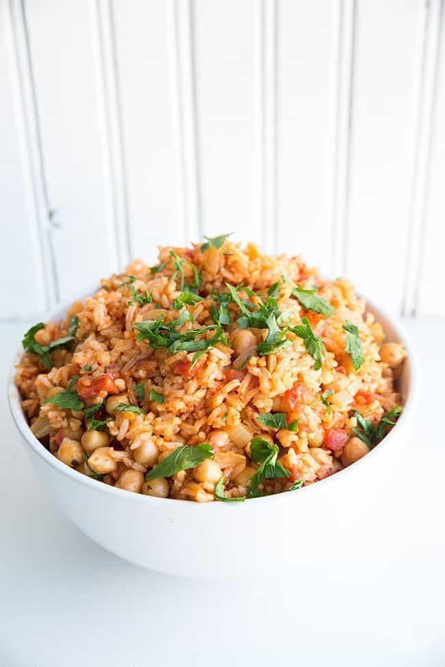 Vegan Smoky Spanish Rice & Chickpeas in a white bowl on white background