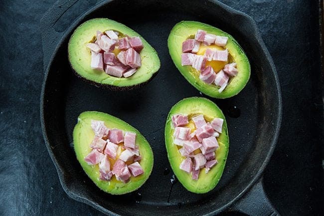 Bacon added in each half of avocado with cracked eggs 