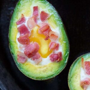 close up eggs baked avocado with pancetta on top