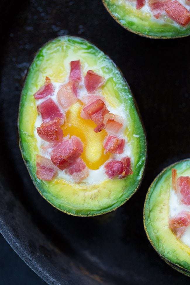 close up eggs baked avocado with pancetta on top