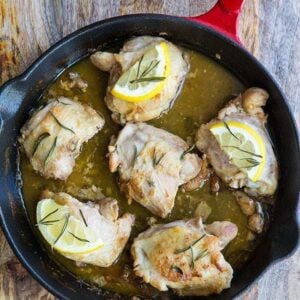 close up Rosemary Lemon Oven Baked Chicken Thighs in red skillet