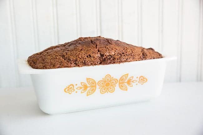 Cinnamon Swirl Loaf in a White Pyrex loaf pan with Floral print on White Background