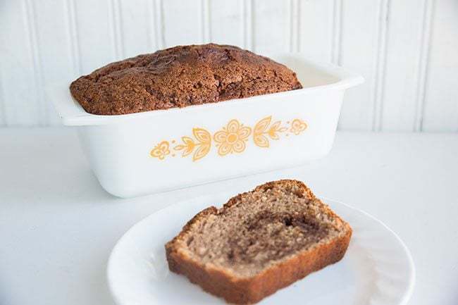 Cinnamon Bread in White Pyrex Loaf Pan and a Slice in a White Plate