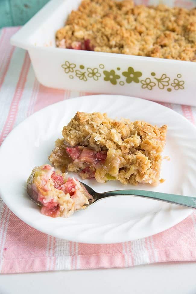 Coconut Rhubarb Crunch in a white plate and in a baking dish