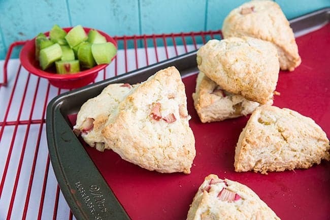  Coconut Rhubarb Scones on a red lined baking sheet