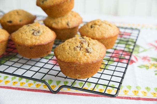 Classic Oatmeal Raisin Muffins on a black cooling rack