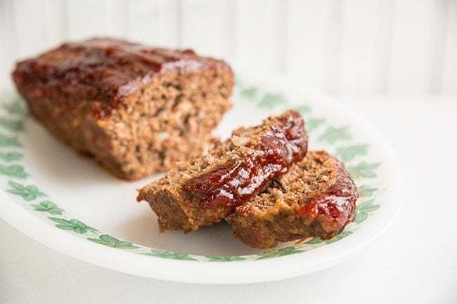 close up of sliced Retro Sweet & Sour Meatloaf in a white plate with white background