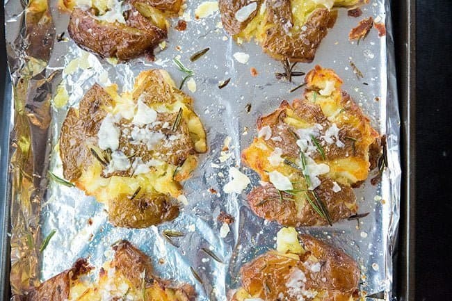 Rosemary Garlic Smashed Potatoes in a large baking sheet lined with tin foil