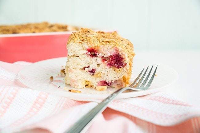 A reduce of Strawberry Plum Crumb Cake in a White plate with Fork  Strawberry Plum Disintegrate Cake Strawberry Plum Crumble Cake2