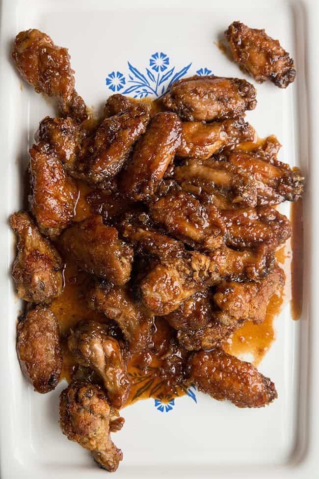 close up Saucy Japanese Chicken Wings in a white serving