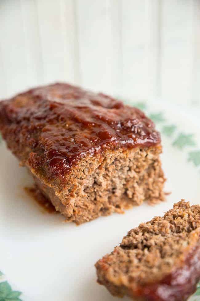close up of sliced Retro Sweet & Sour Meatloaf in a white plate with white background