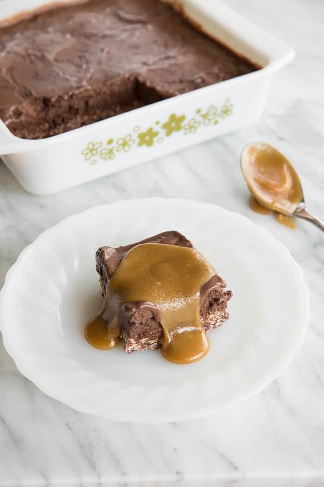 Chocolate Truffle Squares with caramel sauce in a white plate and in a baking pan
