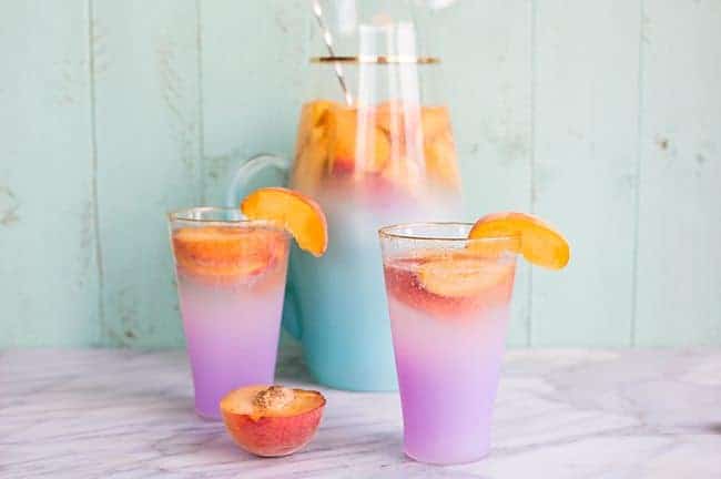 close up of Sparkling Peach Sangria garnish with a slices of fresh Peach