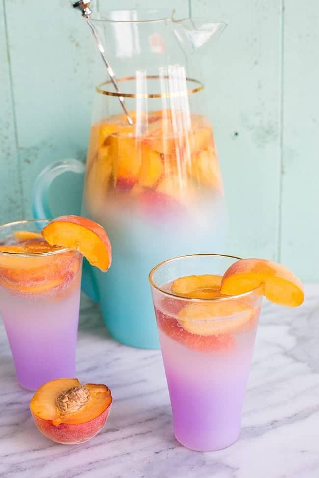 close up of Sparkling Peach Sangria garnish with a slices of fresh Peach