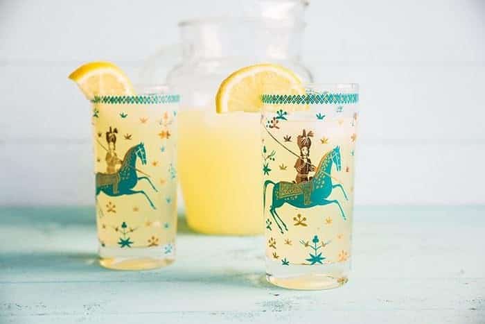 Sparkling Honey Bourbon Lemonade in pitcher and in two glasses with Arabian design