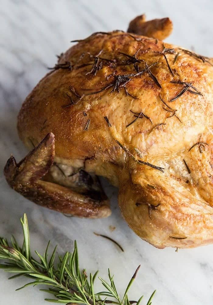 close up of Whole Roasted Chicken with rosemary