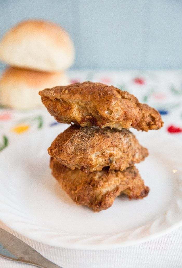 close up of 3 stack Crispy Air Fryer Chicken on white plate