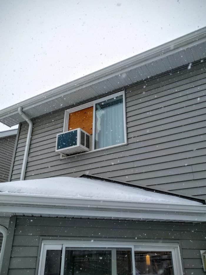 a window air conditioner in a snow storm