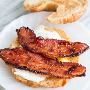 BBQ Glazed Bacon & Eggs in slices of Croissants on a marble background