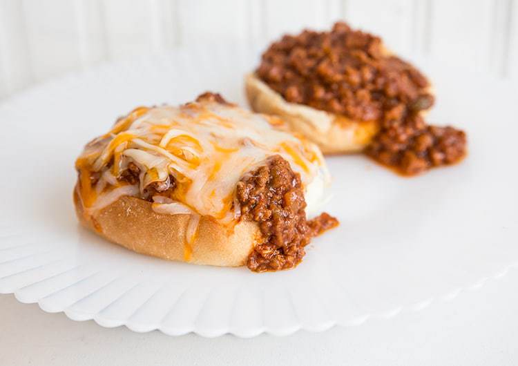 2 servings of buns topped with Sloppy Joes and cheese