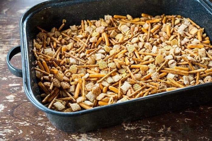 mixed Rice Chex, Crispix cereals, nuts, crackers and pretzel on a large roaster