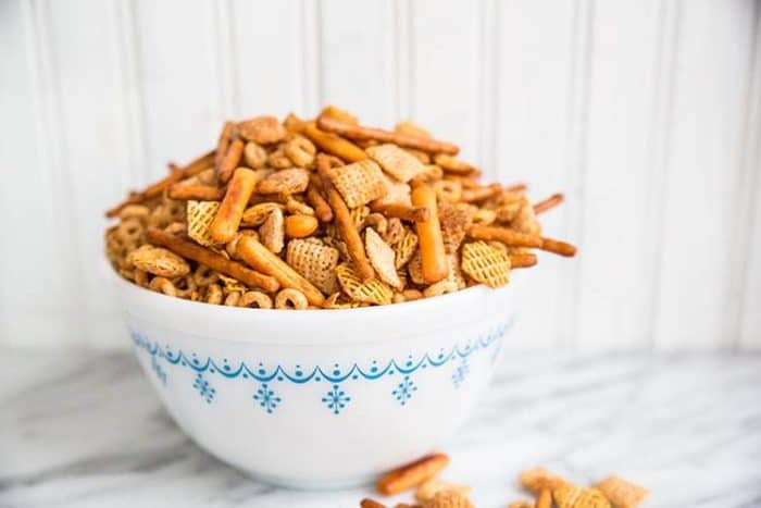 Homemade Nuts and Bolts in a white bowl on white background 