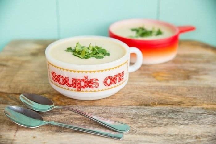 Potato leek soup on a soup bowls, 2 spoons on side