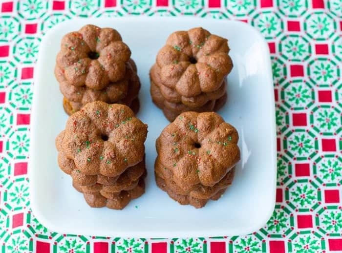 4 stacks of cute Cookie Press Gingersnap Cookies in a white plate