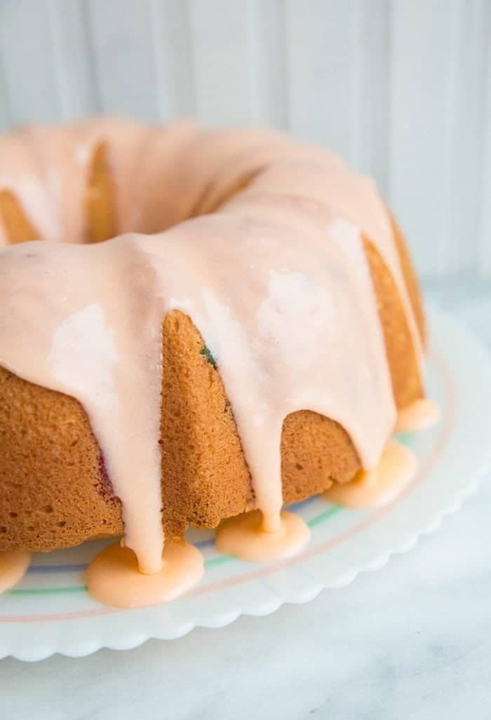 close up delicious Gumdrop Cake glazed with pink icing on white background