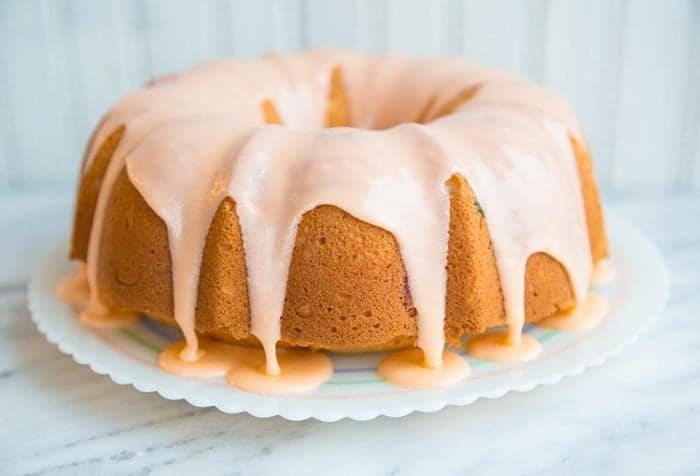 Decadent and delicious Gumdrop Cake glazed with pink icing in a white plate