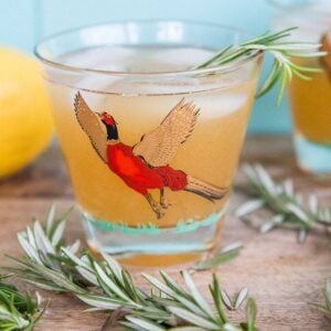 Maple Rosemary Bourbon Sour in a pheasant cocktail glasses with springs of rosemary