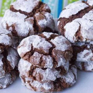 close up stacks of Classic Chocolate Crinkle Cookies in a white plate