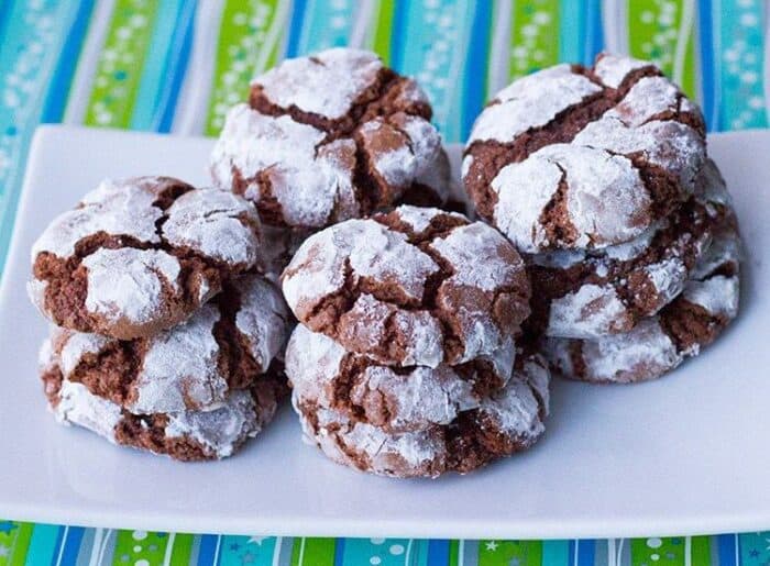 Classic Chocolate Crinkle Cookies in a white plate, blue and green colored table cloth underneath