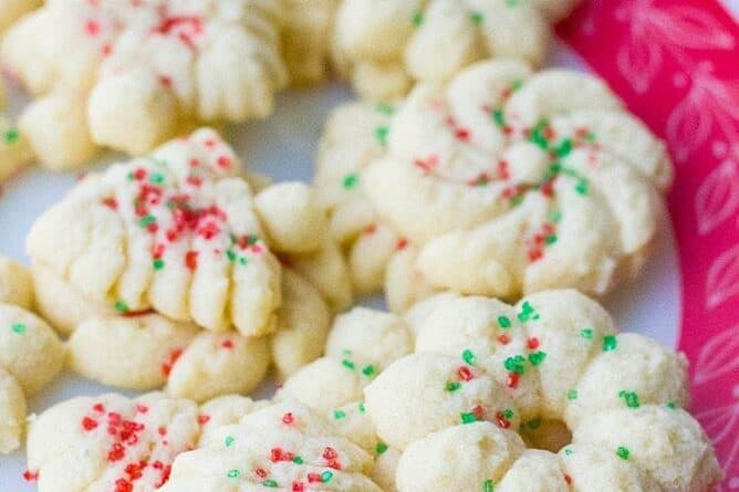 Old Fashioned Classic Spritz Cookies of different shapes sprinkled with candies colored sugar