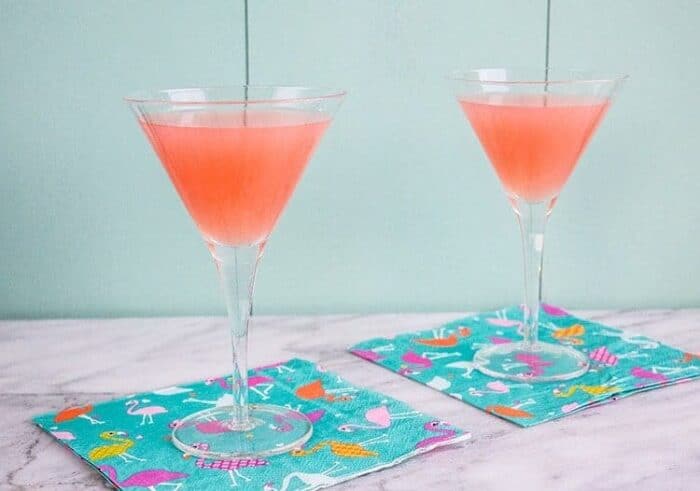 Two Glasses of Greyhound Cocktails on blue green background