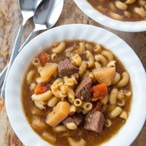 Top down shot of Beef Macaroni Soup in beef broth based on wood background