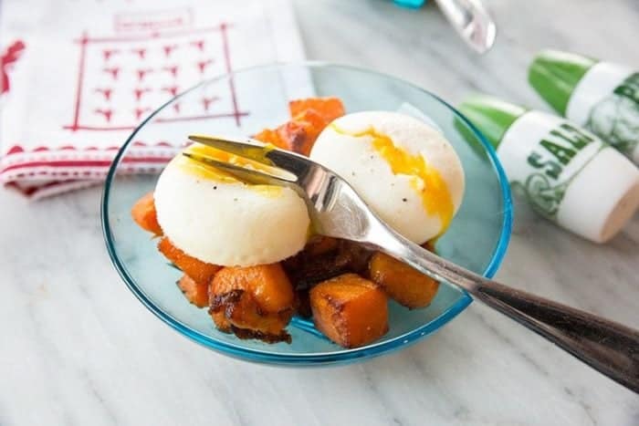 Maple Roasted Butternut Squash on transparent plate topped with poached eggs