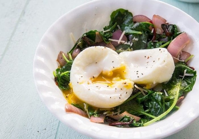 Mixed Greens & Cajun Onions Vegetable Breakfast Goal Bowl with poached egg on top