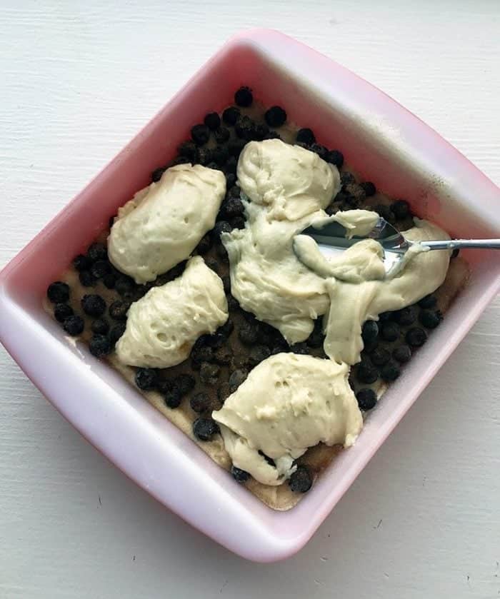 Coffee Cake batter in a baking pan with blueberries added